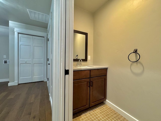 bathroom with vanity and hardwood / wood-style flooring