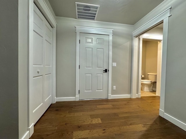 hall with dark hardwood / wood-style flooring