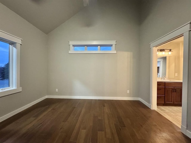 spare room featuring hardwood / wood-style floors and lofted ceiling