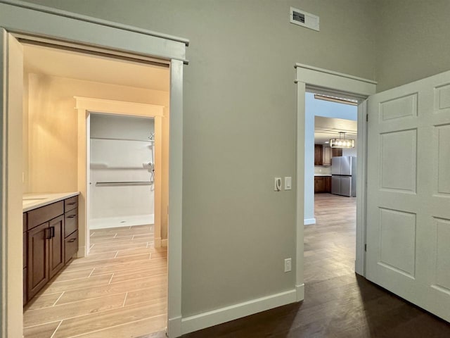 hallway with light hardwood / wood-style flooring