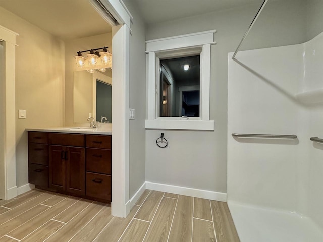 bathroom with a shower and vanity