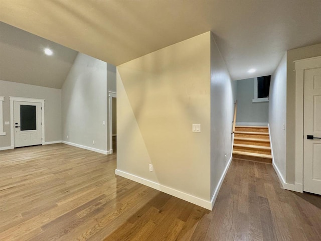 interior space with light hardwood / wood-style flooring and vaulted ceiling