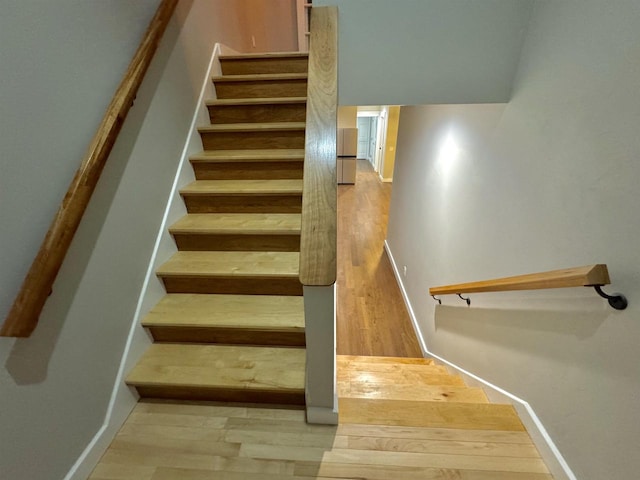 stairs featuring wood-type flooring