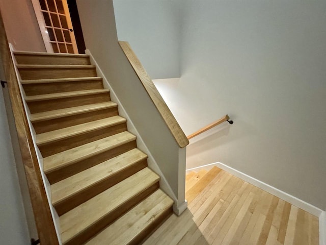 stairway with hardwood / wood-style flooring