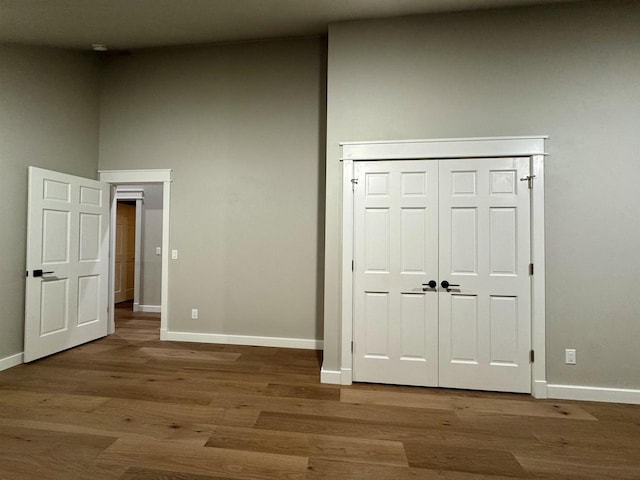 unfurnished bedroom featuring a closet and hardwood / wood-style flooring