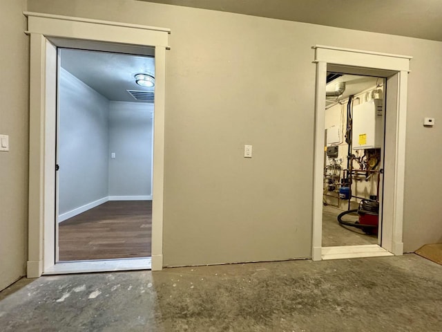 interior space featuring tankless water heater and concrete floors