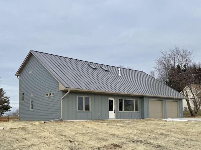 rear view of property with a garage