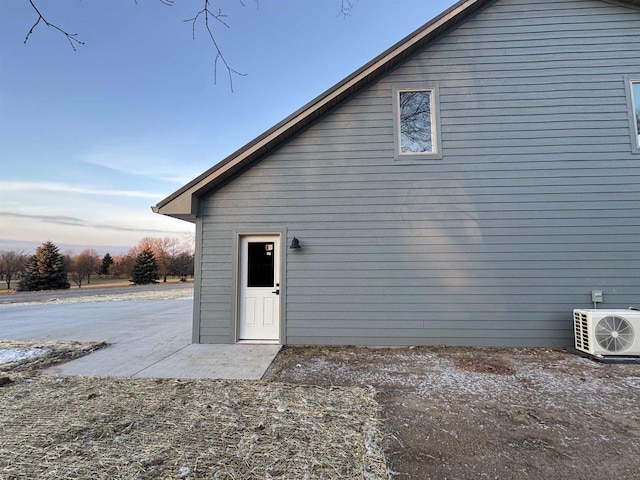 exterior space with ac unit and a patio