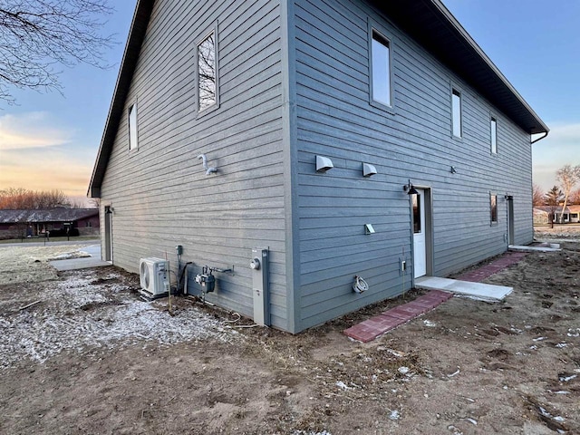 property exterior at dusk with ac unit