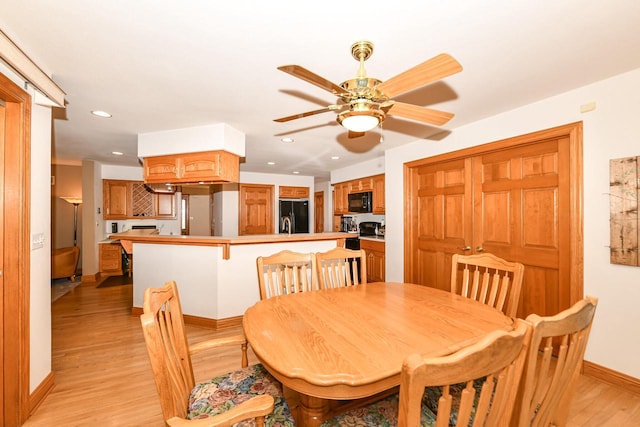 dining area with ceiling fan and light wood-type flooring