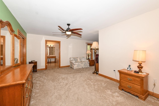 living area with light carpet and ceiling fan