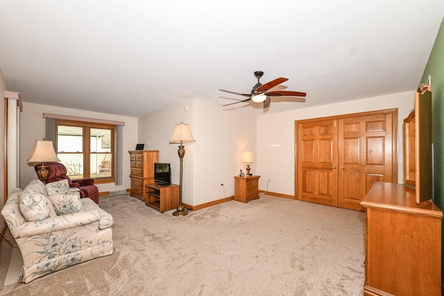 living room featuring light colored carpet and ceiling fan