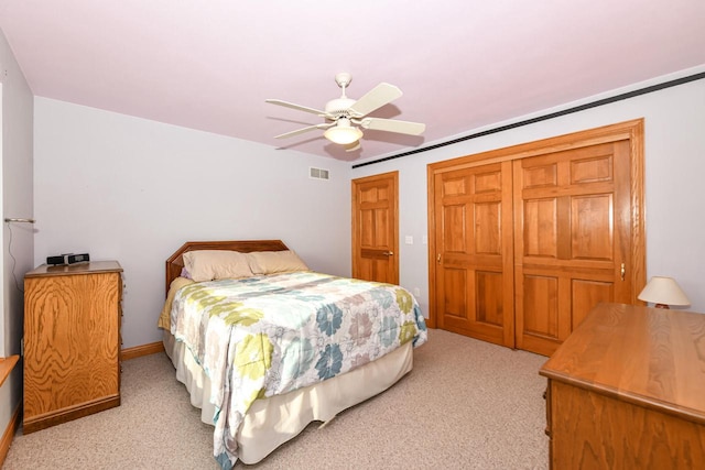 bedroom featuring ceiling fan and light carpet