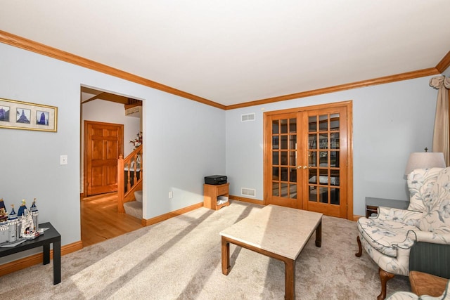 carpeted living room with crown molding and french doors