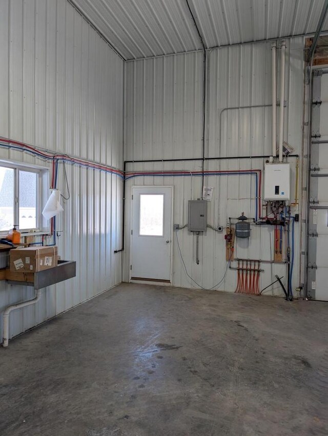 W3476 Chickadee Rd, Loyal, WI 54446 - garage featuring electric panel, water heater, and metal wall
