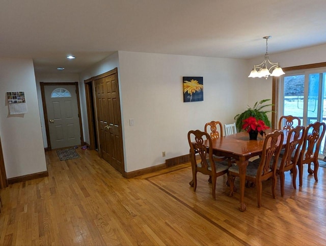 dining room featuring hardwood / wood-style floors and a notable chandelier