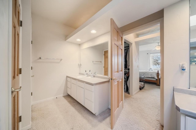 bathroom with ceiling fan and vanity