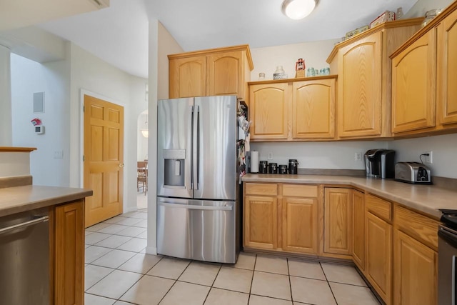 kitchen featuring stainless steel appliances and light tile patterned flooring