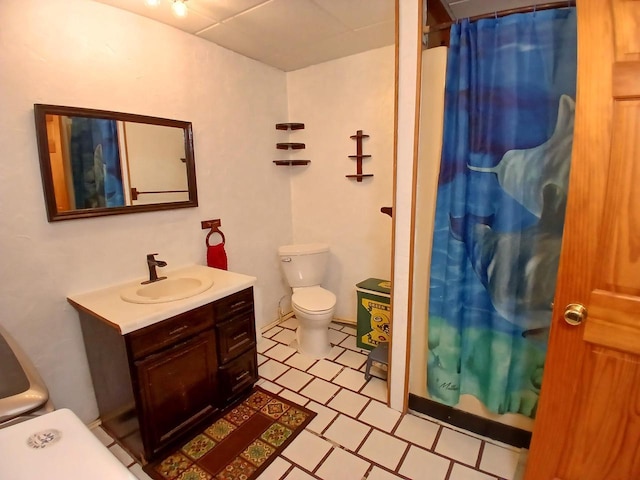 bathroom featuring a shower with curtain, vanity, toilet, and tile patterned floors