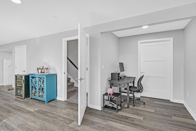 office space with hardwood / wood-style flooring and wine cooler