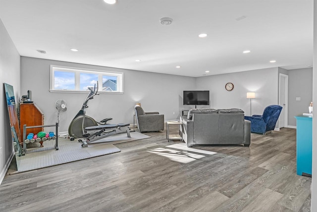 exercise room with light hardwood / wood-style floors