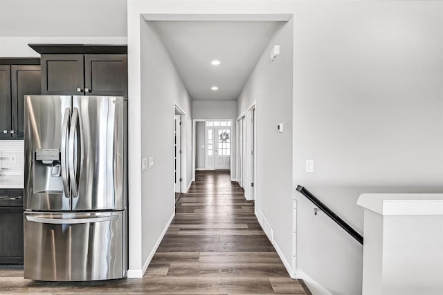 kitchen featuring stainless steel fridge, french doors, dark hardwood / wood-style floors, dark brown cabinetry, and tasteful backsplash