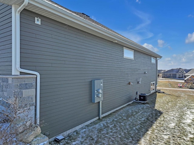 view of side of home with central AC unit