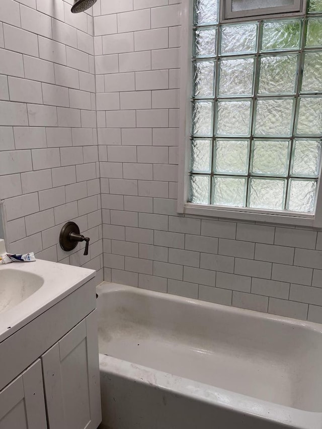 bathroom with vanity and tiled shower / bath combo