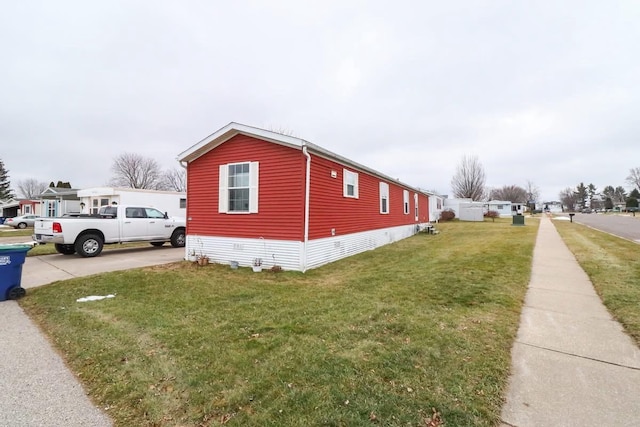 view of side of property with a yard