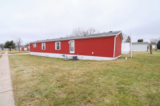 view of home's exterior featuring a yard and central AC unit