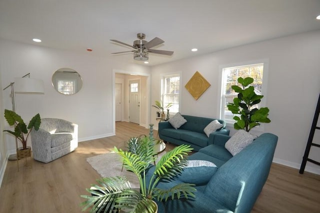 living room featuring hardwood / wood-style flooring, ceiling fan, and a healthy amount of sunlight