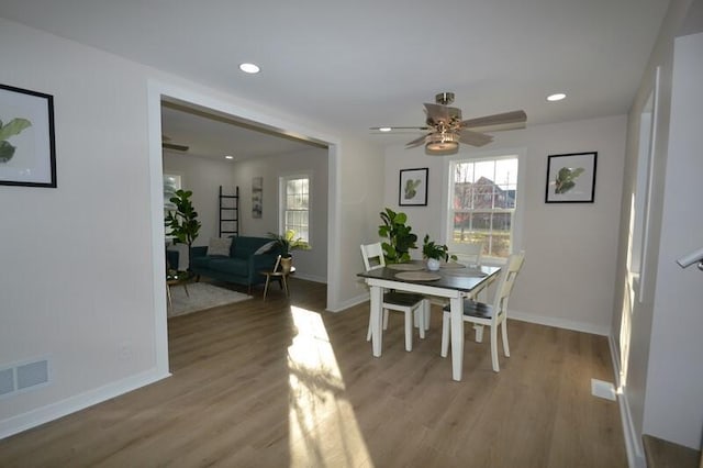 dining room with light hardwood / wood-style flooring and ceiling fan