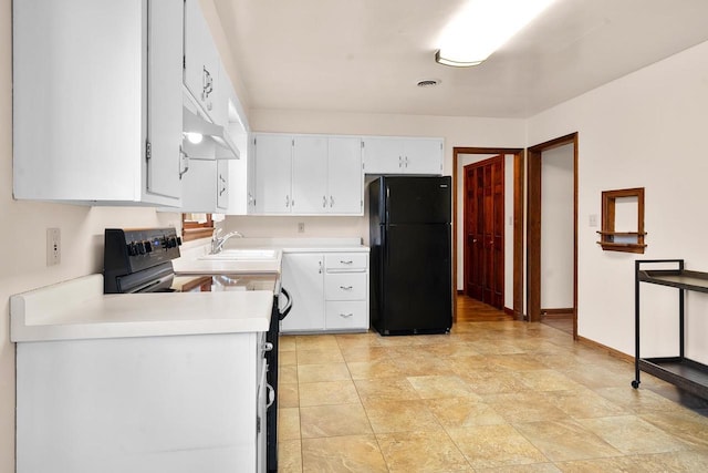 kitchen featuring white cabinets, black fridge, stove, and sink