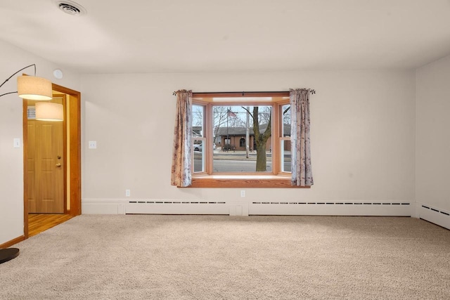 spare room with carpet floors and a baseboard radiator