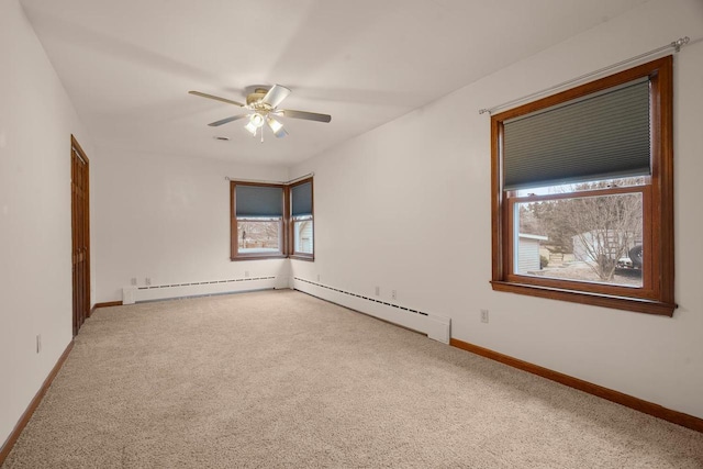 spare room featuring ceiling fan, carpet floors, and a baseboard radiator