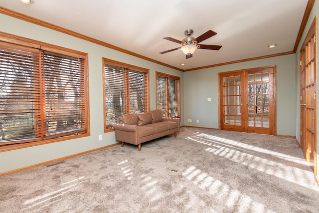 unfurnished room featuring carpet flooring, crown molding, french doors, and ceiling fan