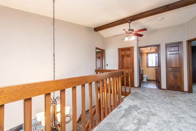 hallway with carpet and lofted ceiling with beams