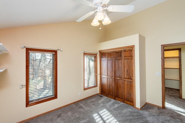 unfurnished bedroom featuring carpet floors, a closet, vaulted ceiling, and ceiling fan