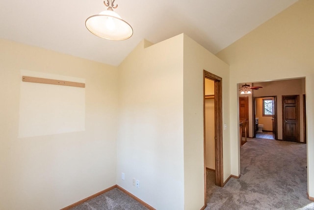 corridor featuring carpet and vaulted ceiling