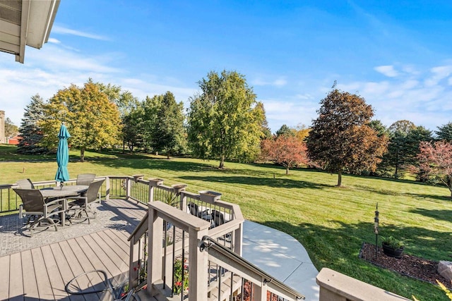 wooden deck featuring a lawn