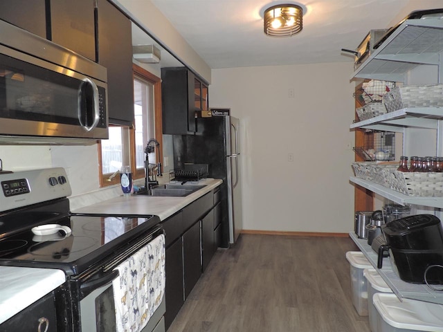 kitchen featuring tasteful backsplash, sink, stainless steel appliances, and dark hardwood / wood-style floors