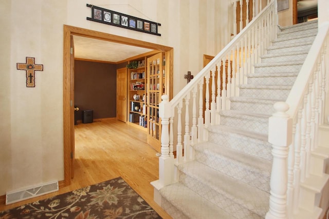 stairway with hardwood / wood-style flooring