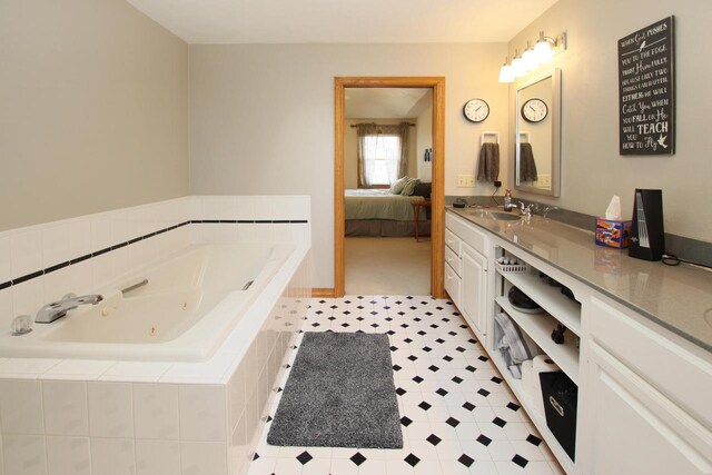 bathroom with vanity and a relaxing tiled tub