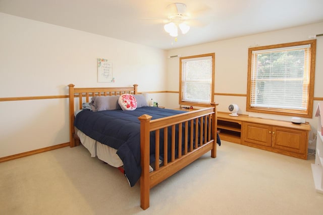 bedroom featuring ceiling fan and light carpet