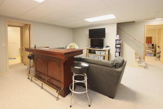 bar featuring a drop ceiling and light colored carpet