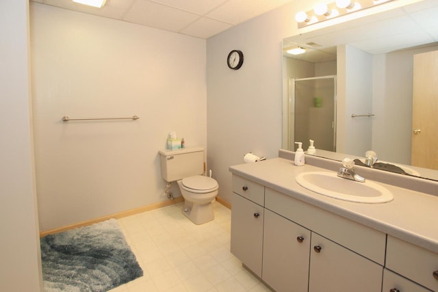 bathroom with walk in shower, a paneled ceiling, vanity, and toilet