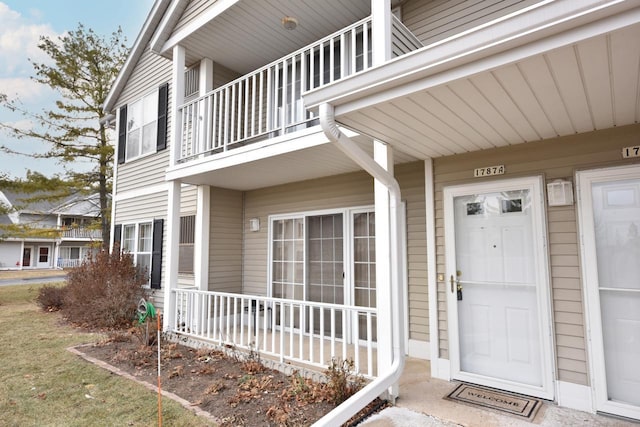 entrance to property with a balcony and a porch