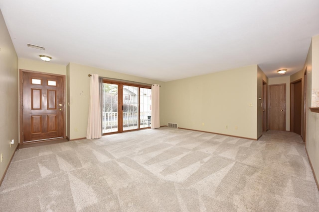 unfurnished living room with light colored carpet