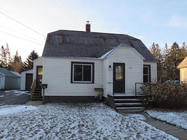 bungalow-style house with an outbuilding and a garage