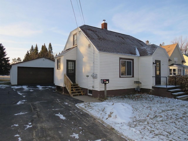 view of front facade with a garage and an outbuilding